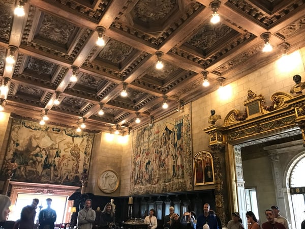 Ornate interior hall at Hearst Castle with coffered ceiling, tapestries, and classical sculptures displayed on walls… — Hearst Castle, Big Sur & the Highway 1 Coast