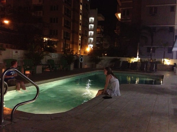 Illuminated resort pool at night with guests and multi-story hotel building in background at Courtyard by Marriott San… — Viejo San Juan, San Juan