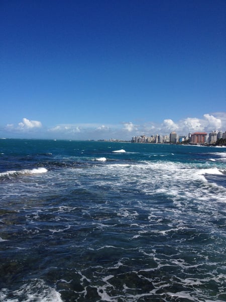 Urban beach with breaking waves and high-rise skyline viewed from the shore at Caribe Hilton, San Juan, Puerto Rico. — Viejo San Juan, San Juan