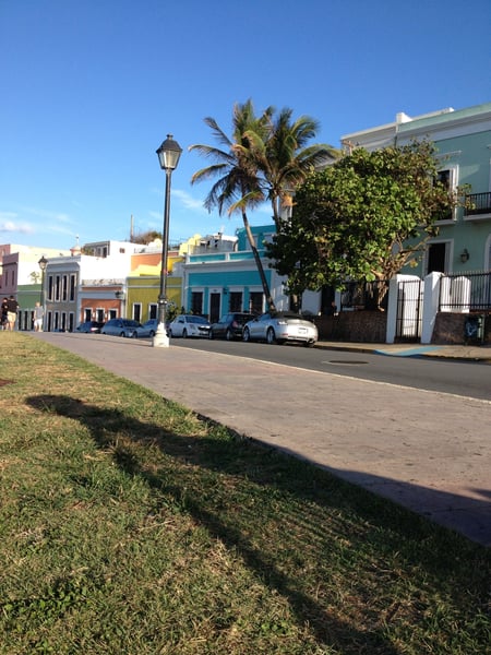 Colorful colonial buildings line a street in Old San Juan, featuring pastel-painted facades and palm trees under clear… — Viejo San Juan, San Juan
