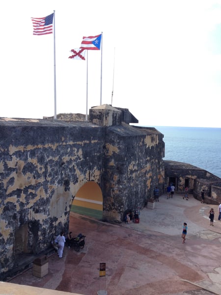 Fort San Felipe del Morro's stone fortification with American and Puerto Rican flags overlooking the Atlantic coast in… — Faro del Castillo San Felipe del Morro, San Juan