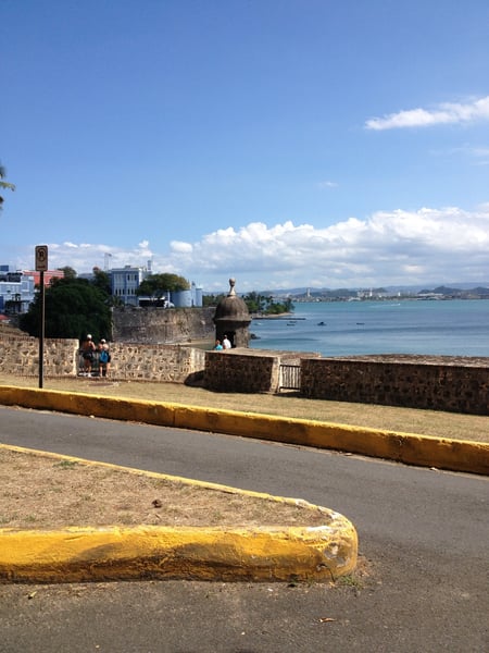 Historic stone fortress with sentry tower overlooking a blue bay and coastal city in San Juan, Puerto Rico. — Viejo San Juan, San Juan