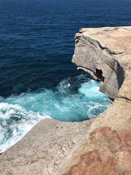 Dramatic coastal rock formation with turquoise waters and breaking waves, viewed from clifftop vantage point near… — Clovelly, Sydney