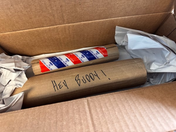 Rolled barber pole and postal tubes packed in a cardboard shipping box with protective paper. — South Philadelphia, Philadelphia