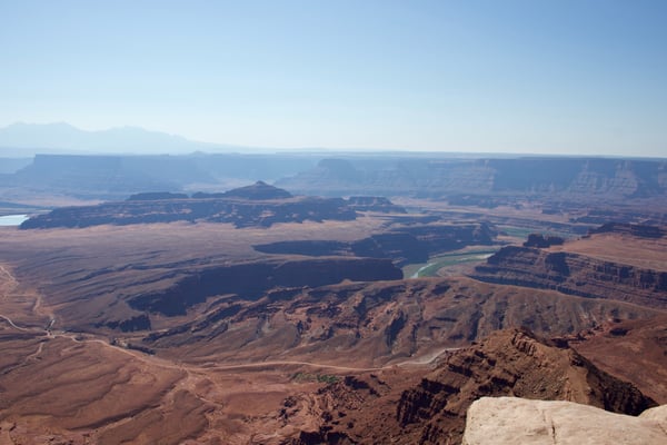 Aerial view of a vast desert landscape with layered mesas, buttes, and a winding river through arid terrain near Moab… — Dead Horse Point State Park, Moab, Arches & Canyonlands