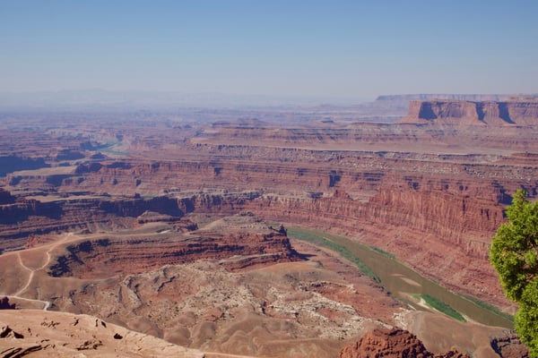 Expansive desert landscape with layered red rock formations and a winding river viewed from a high overlook near Moab… — Dead Horse Point State Park, Moab, Arches & Canyonlands