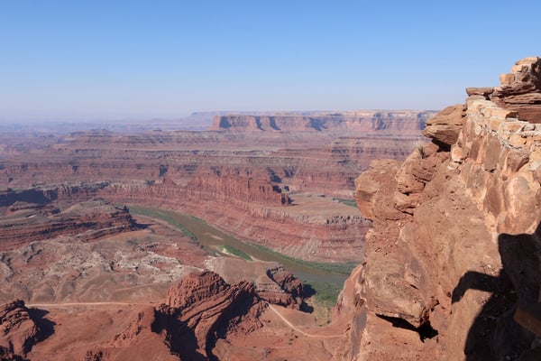 Aerial view of Canyonlands National Park showing the Colorado River winding through layered red rock formations and… — Moab, Arches & Canyonlands