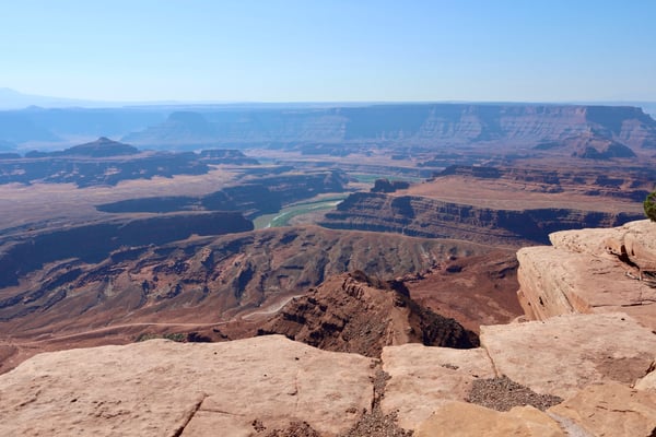Canyon landscape with mesa formations and a winding river viewed from a high desert overlook near Moab, Utah. — Dead Horse Point State Park, Moab, Arches & Canyonlands