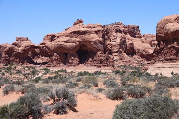 Massive red sandstone rock formations with natural caves in Castle Valley, Utah desert landscape. — Arches National Park, Moab, Arches & Canyonlands