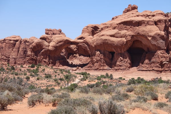 Natural rock arches and towering red sandstone formations in Castle Valley, Utah, viewed from the desert floor. — Arches National Park, Moab, Arches & Canyonlands
