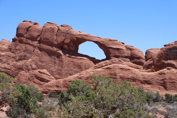Skyline Arch, a natural stone arch formation in red sandstone, viewed from the trail in Moab, Utah. — Moab, Arches & Canyonlands