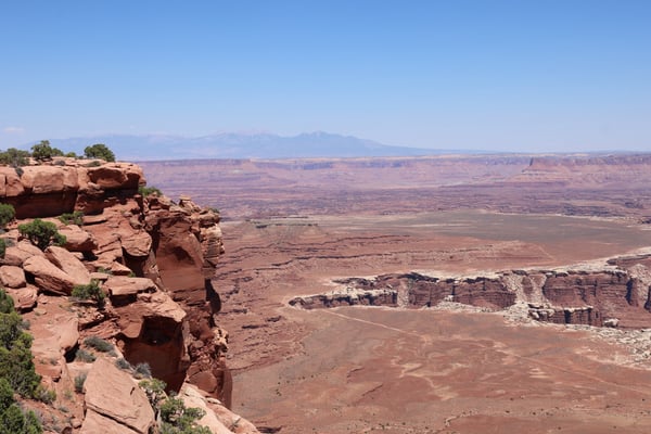 Red rock formations and expansive desert landscape viewed from Grand View Point Overlook in Moab, Utah, with mountains… — Grand View Point Overlook, Moab, Arches & Canyonlands