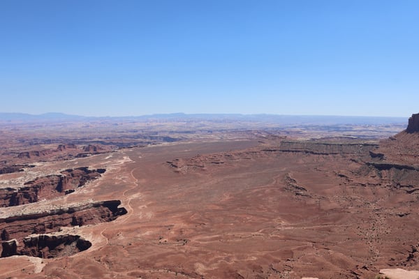 Vast desert landscape with winding river and distant buttes viewed from Grand View Point Overlook in Moab, Utah. — Grand View Point Overlook, Moab, Arches & Canyonlands