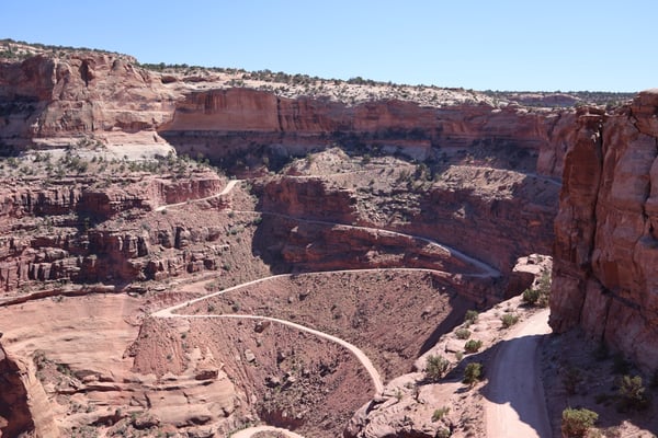 Shafer Canyon Overlook viewed from above, showing red rock formations, winding road, and a river cutting through the… — Shafer Canyon Overlook, Moab, Arches & Canyonlands