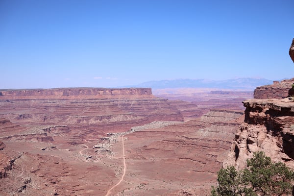 Expansive desert canyon landscape with layered red rock formations and winding road seen from Shafer Canyon Overlook in… — Shafer Canyon Overlook, Moab, Arches & Canyonlands