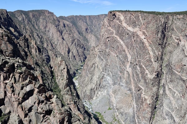 Steep canyon walls frame a narrow river valley at Painted Wall View, Colorado, photographed from a clifftop overlook. — Painted Wall View, Black Canyon of the Gunnison