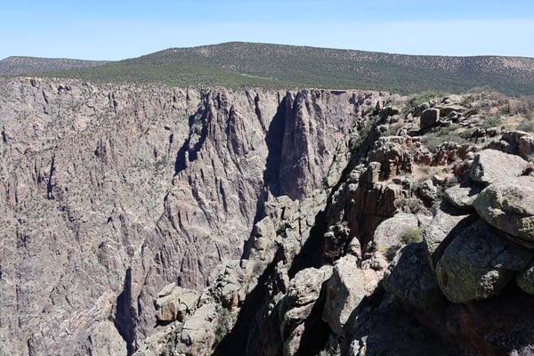 Narrow canyon with columnar rock formations viewed from Sunset View overlook in Crawford, Colorado. — Black Canyon of the Gunnison