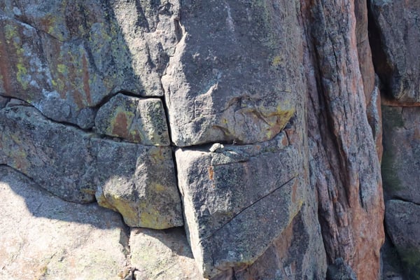 Weathered rock formation with lichen and deep natural cracks at Painted Wall View, showing geological stratification… — Painted Wall View, Black Canyon of the Gunnison