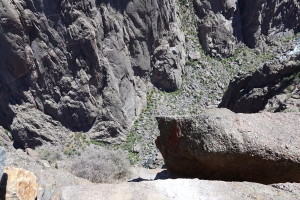 Deep rocky canyon with exposed stratified rock walls and sparse alpine vegetation at Chasm View near Montrose, Colorado. — Chasm View, Black Canyon of the Gunnison