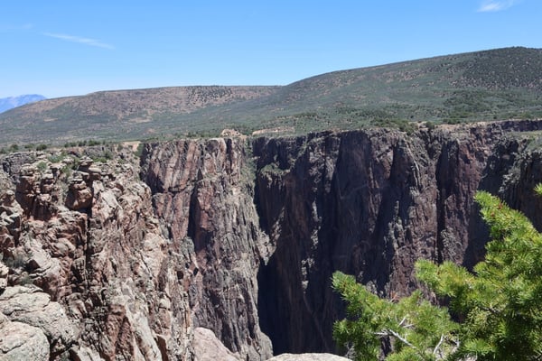 Columnar basalt rock formations at Rock Point, Montrose, Colorado, viewed from an overlook with semiarid hillsides in… — Rock Point, Black Canyon of the Gunnison