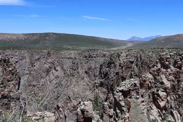 Deep rocky canyon with layered cliff walls and forested ridges viewed from a high vantage point at Rock Point, Colorado. — Rock Point, Black Canyon of the Gunnison