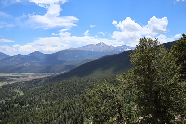 Expansive mountain valley with forested slopes and snow-capped peaks viewed from Many Parks Curve Overlook on Trail… — Many Parks Curve Overlook, Rocky Mountain National Park
