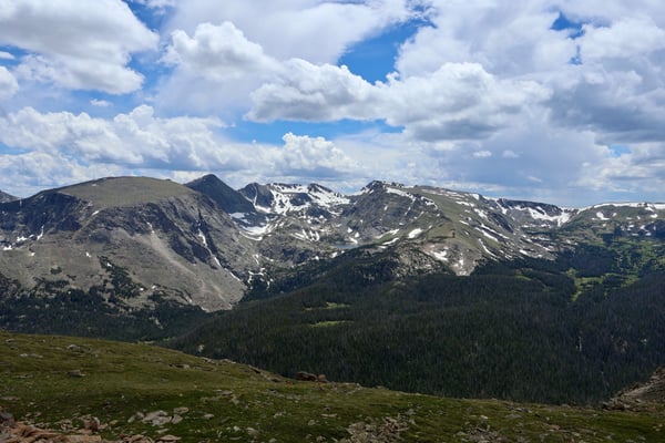 Alpine mountain range with coniferous forests and residual snow patches viewed from Tundra Communities Trailhead in… — Tundra Communities Trailhead, Rocky Mountain National Park
