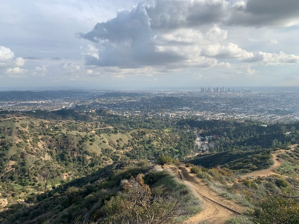 Los Angeles skyline viewed from Griffith Park hillside overlooking sprawling urban landscape and surrounding hills. — Griffith Park, Los Angeles