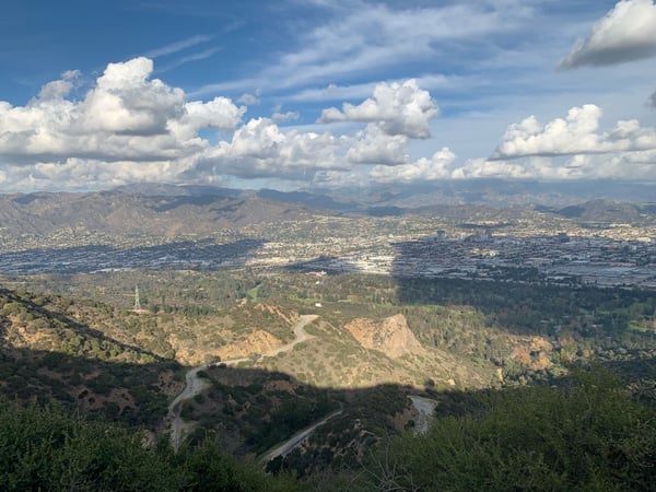 Aerial view of Los Angeles basin with winding river, forested foothills, and distant mountains from a high vantage… — Griffith Park, Los Angeles