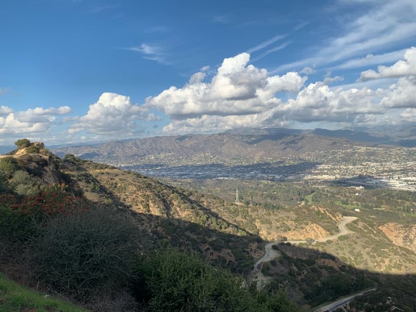 Panoramic valley vista with mountains, winding roads, and scattered development viewed from a hillside overlook in… — Griffith Park, Los Angeles