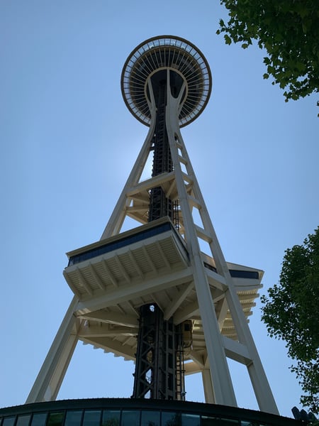 Space Needle observation tower photographed from ground level looking upward against clear blue sky in Seattle. — Space Needle, Seattle