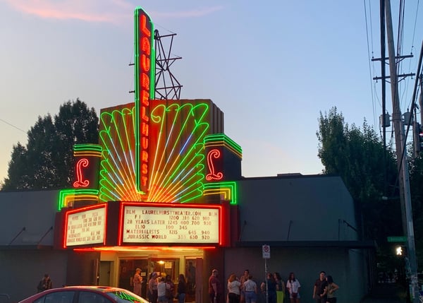 The Laurelhurst Theater's iconic Art Deco neon marquee glowing at dusk in Portland, Oregon, with patrons gathered at… — Buckman, Portland