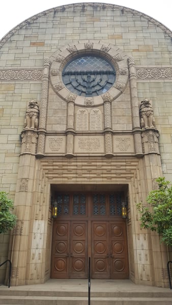 Ornate stone facade of a synagogue with decorative lion sculptures, circular window, and wooden doors in Portland… — Northwest District, Portland