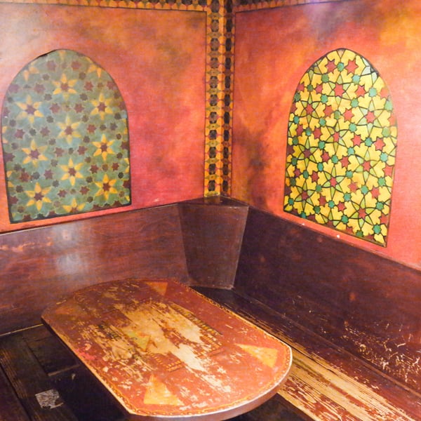 Interior of a decorative booth or room with arched windows featuring Islamic geometric patterns and warm terracotta… — Northwest District, Portland