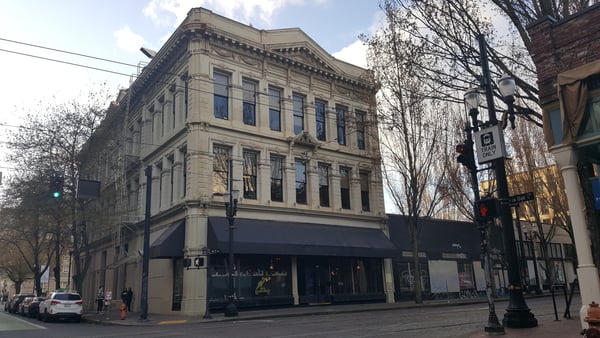 Historic Italianate building with ornate facade and ground-floor retail on a downtown street corner. — Old Town, Portland