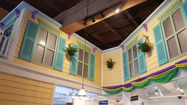 Colorful New Orleans-style building facade with turquoise shutters and yellow walls inside a doughnut shop, decorated… — Downtown, Portland