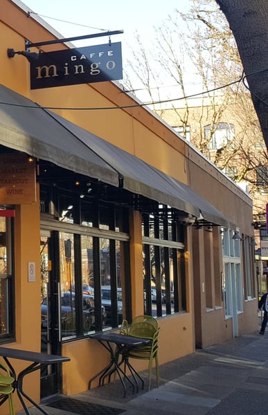 Caffe Mingo storefront with yellow facade, black signage, and outdoor seating on a winter street. — Northwest District, Portland