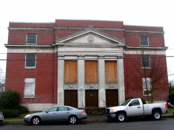 Abandoned Mount Hood Masonic Temple, a red brick building with boarded windows and classical stone portico… — Portland