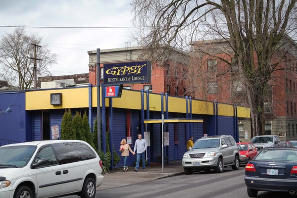 Gypsy Restaurant & Lounge, a blue and yellow storefront with distinctive architectural styling, located on a street… — Northwest District, Portland