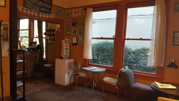 Interior of Anna Bannanas Cafe in Portland, Oregon, showing a warm orange-walled space with vintage furnishings… — Northwest District, Portland
