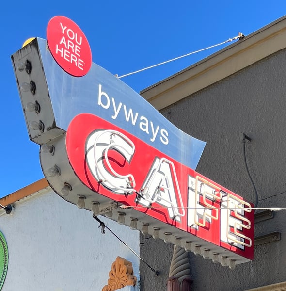 Vintage neon sign for Byways Cafe with "You Are Here" pointer against clear blue sky. — Pearl District, Portland