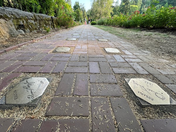 Paved pathway with commemorative tiles and signatures at the International Rose Test Garden in Portland, Oregon. — International Rose Test Garden, Portland