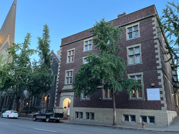 First Presbyterian Church, a red brick historic building with ivy-covered facade and arched entrance, viewed from… — Downtown, Portland